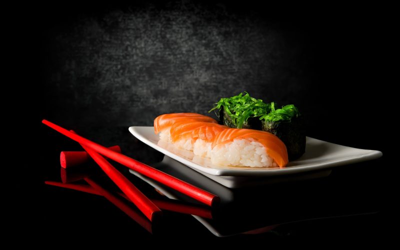 sushi-chopsticks-black-background sushi-chopsticks-black-background