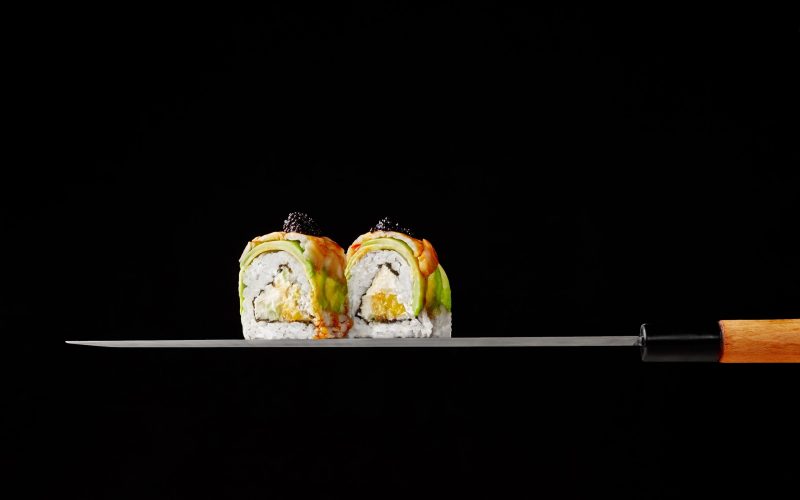 two-uramaki-rolls-with-cream-cheese-mango-avocado-shrimps-blade-japanese-knife-black-ba two-uramaki-rolls-with-cream-cheese-mango-avocado-shrimps-blade-japanese-knife-black-ba